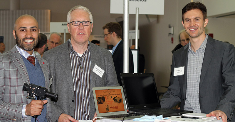 PlenOptika entrepreneurs Shivang Dave (left) and Nick Durr (right), both post docs, with the VMS mentor Ralph Faber MBA ’07 at the 2014 Demo Day event. 