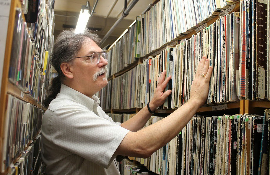 VJ at MIT's WMBR radio station looks though records 