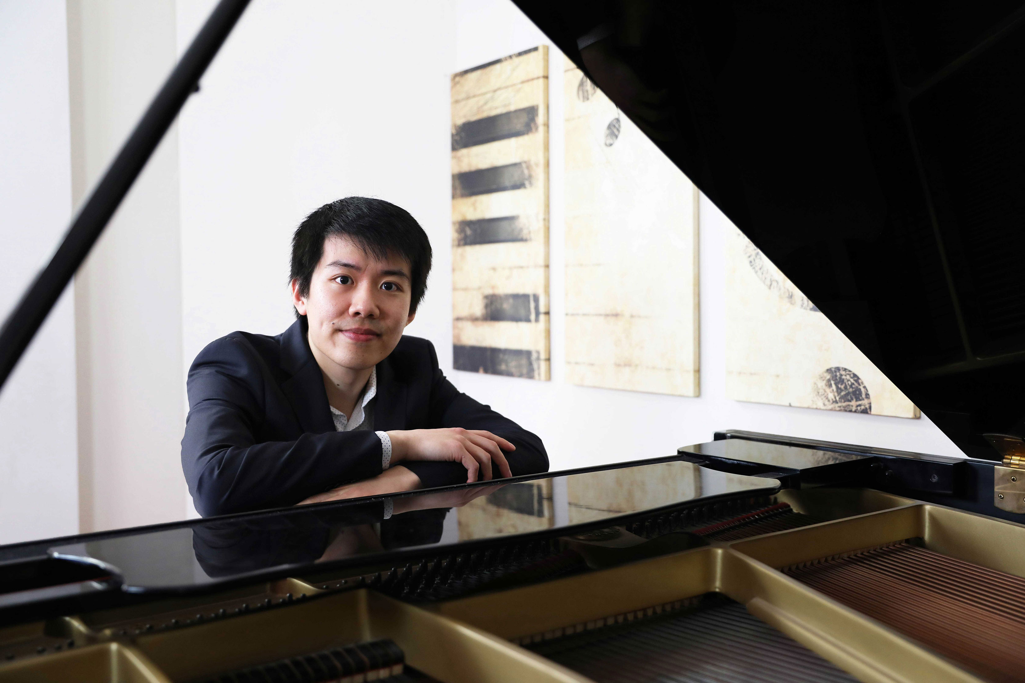 Sitan Chen resting on a piano