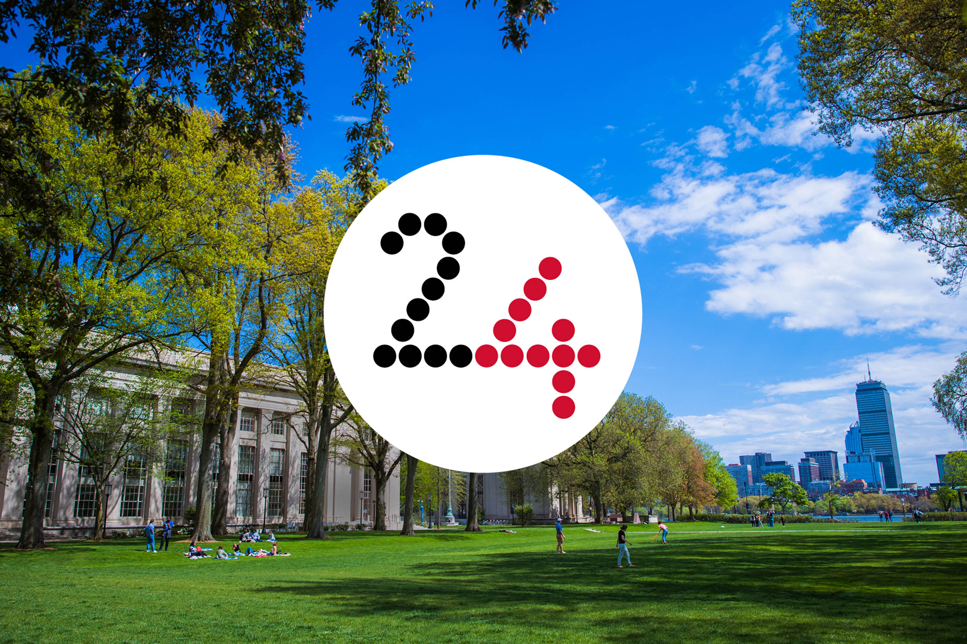 The lawn of Killian Court at MIT with a view to the city of Boston. The number 24 in a white circle overlays the photo.