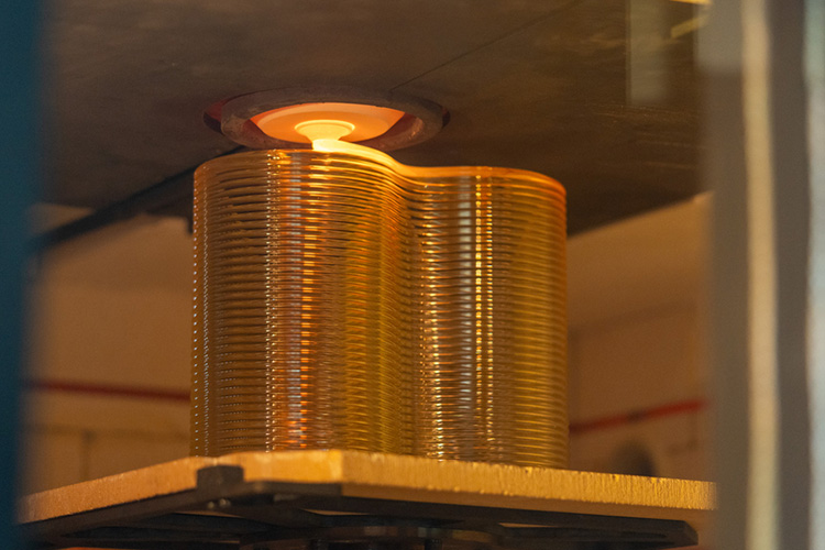 In the hot 3D printer, a tube of glass is extruded as the glass brick is made.