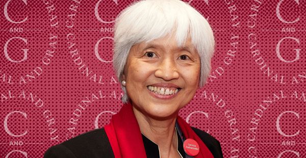 Headshot of Sze-Wen Kuo against a background showing the logo of the Cardinal & Gray Society.